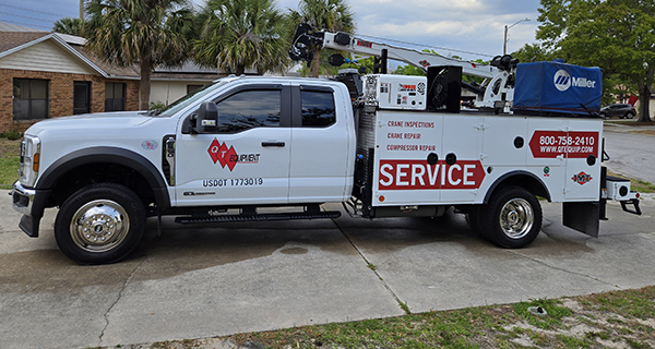 repairs and crane inspections being done on crane truck by service mechanics technicians